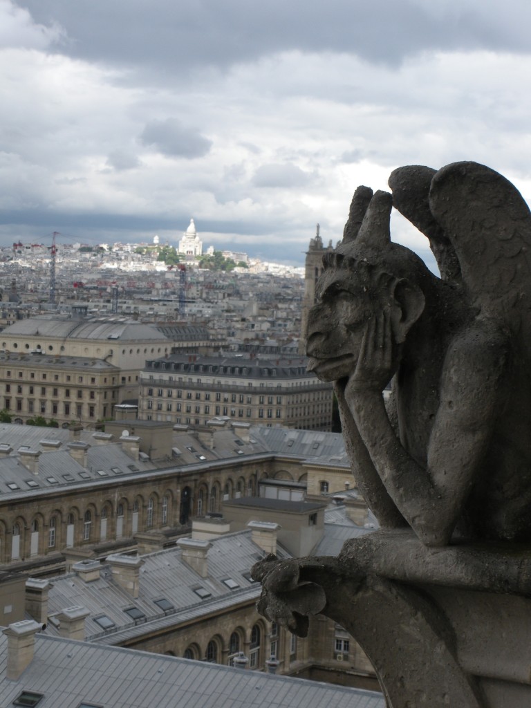 A gargoyle friend with Sacre Coeur in the background, highlighted by the day's few rays of sunshine.